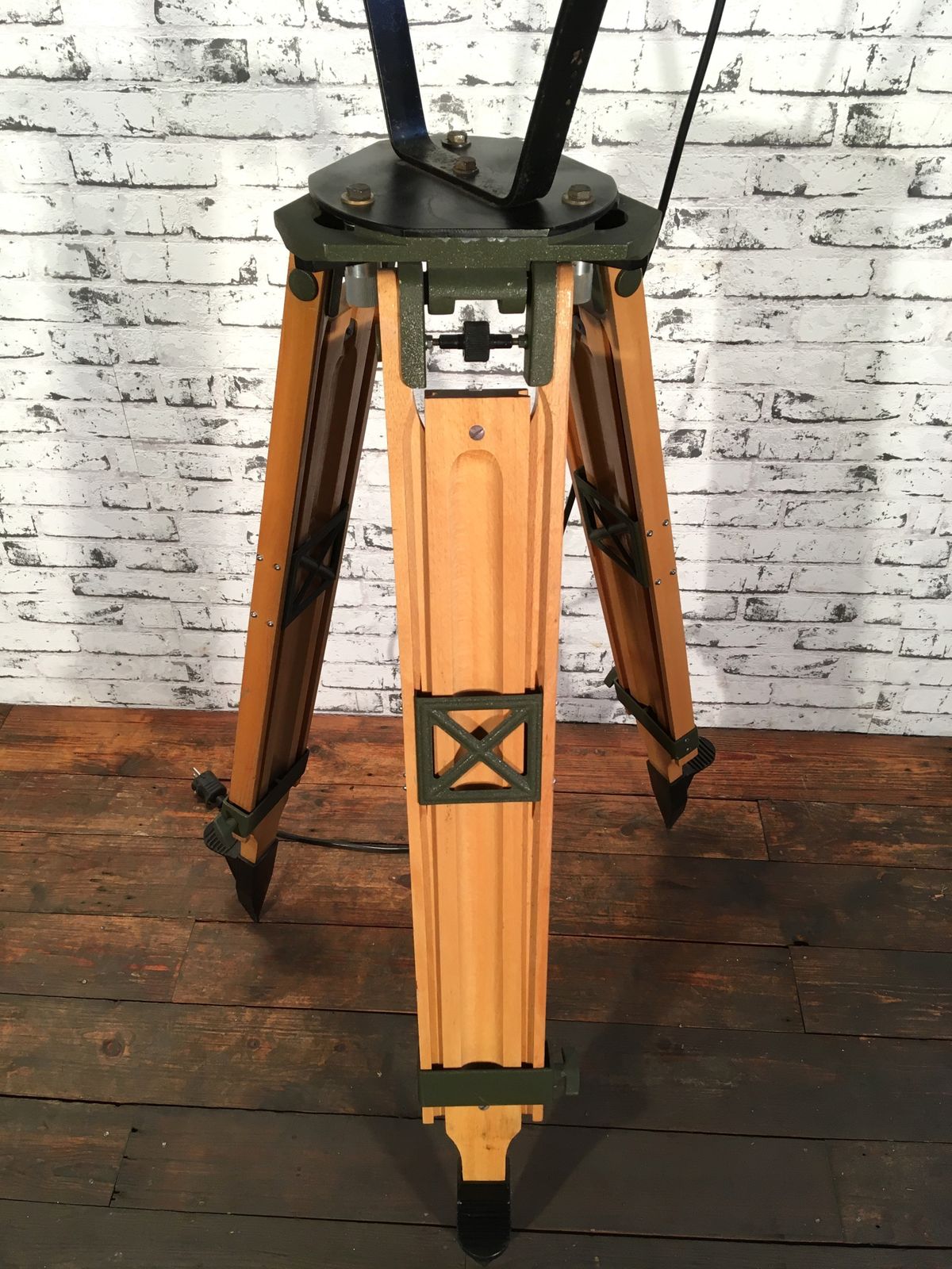 Lighting Black Vintage Industrial Spotlight On Wooden Tripod  photo