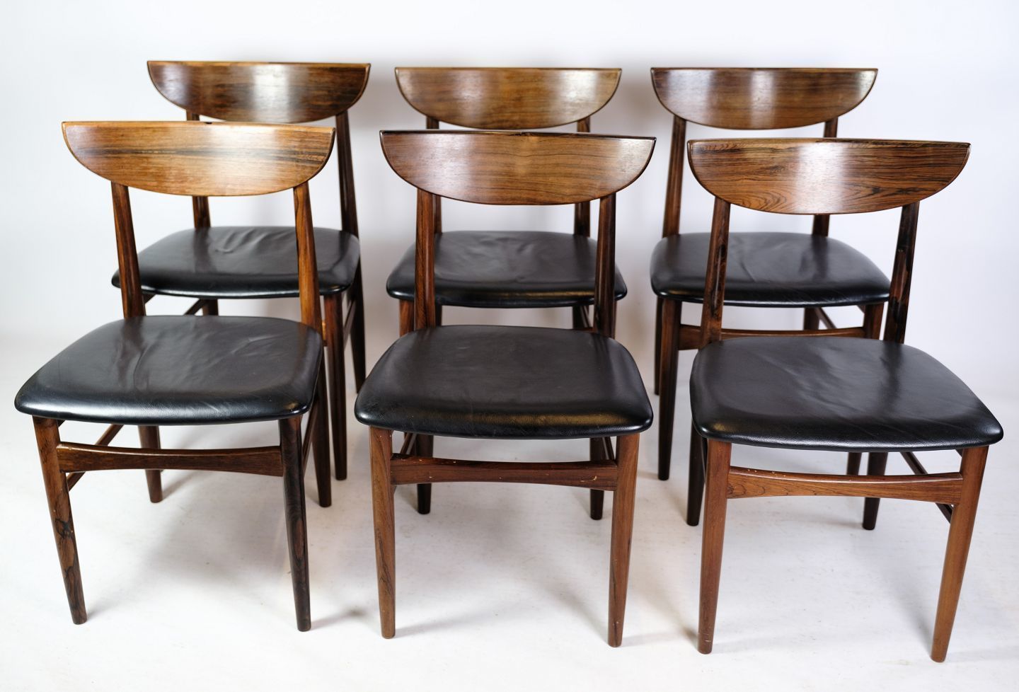 A Set Of Six Dining Table Chairs Of Danish Design In Rosewood With Black Leather From The 1960s.