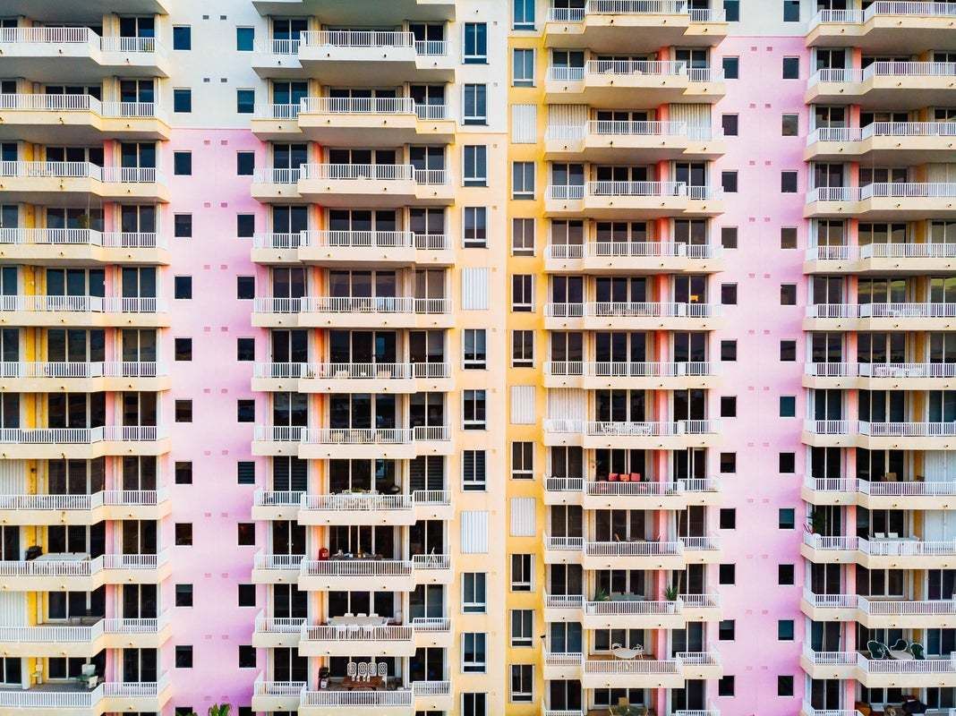 "Drone View Of Colorful Building In Miami With Balcony Levels" By Artur Debat