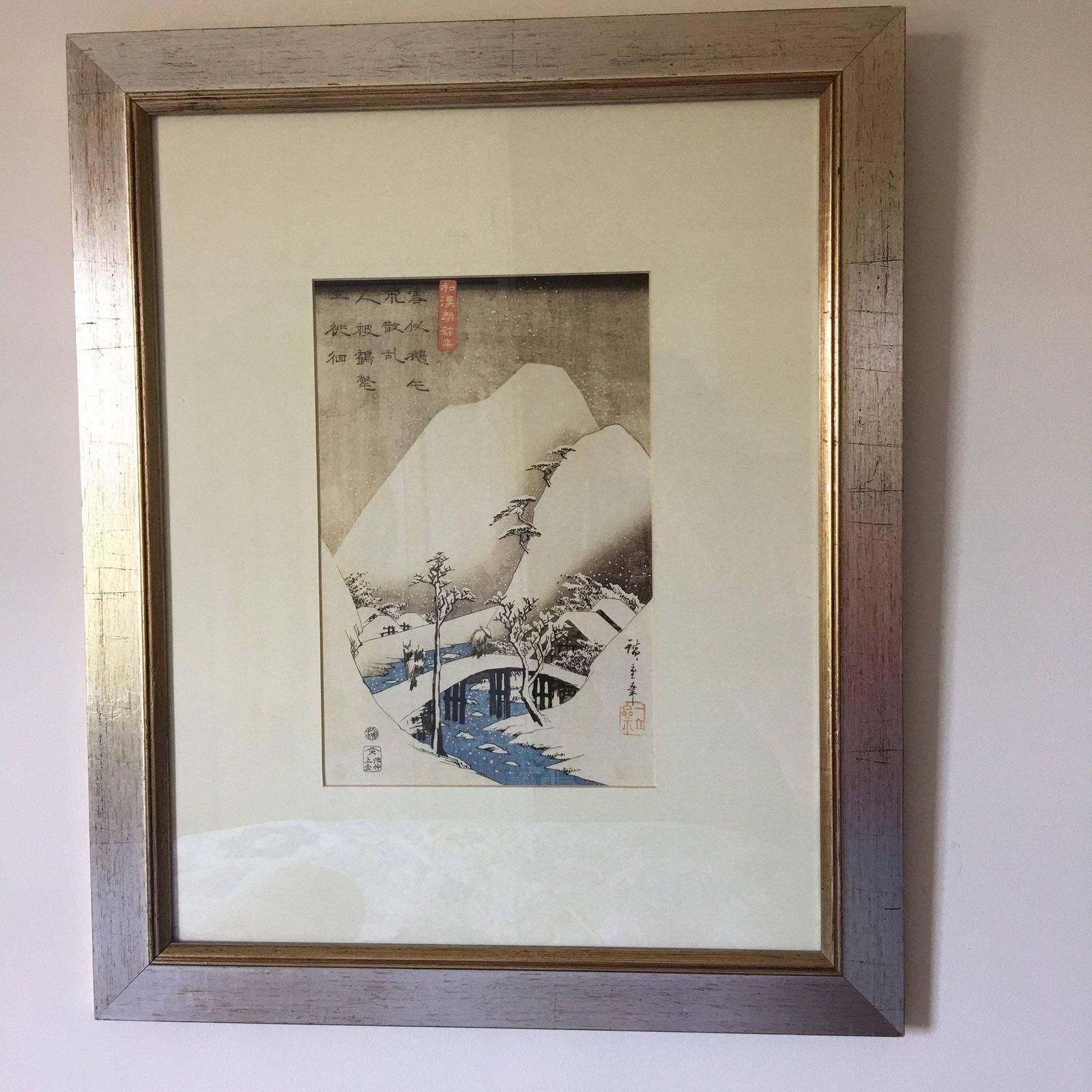 Print Of Japanese Snowy Scene With Bridge In Centre Of Picture Framed In Silver With Gold Inner Boarder photo for sale