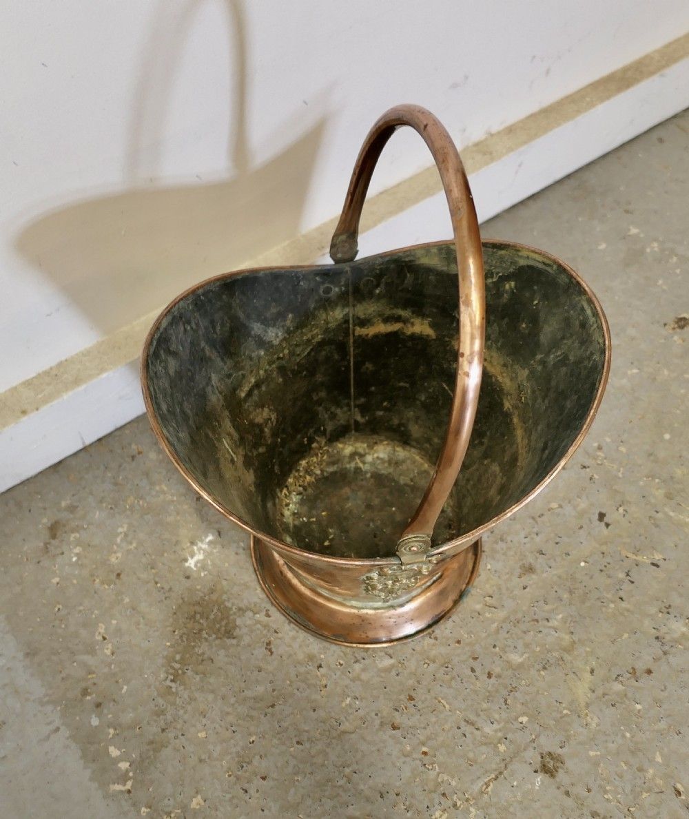An Art Nouveau Embossed Copper Helmet Coal Scuttle photo for sale