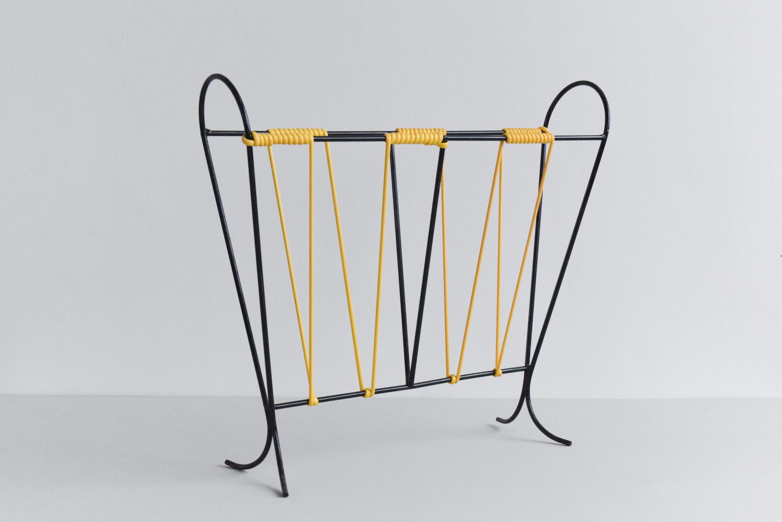 Vintage Black And Yellow Metal And Plastic Magazine Rack photo for sale