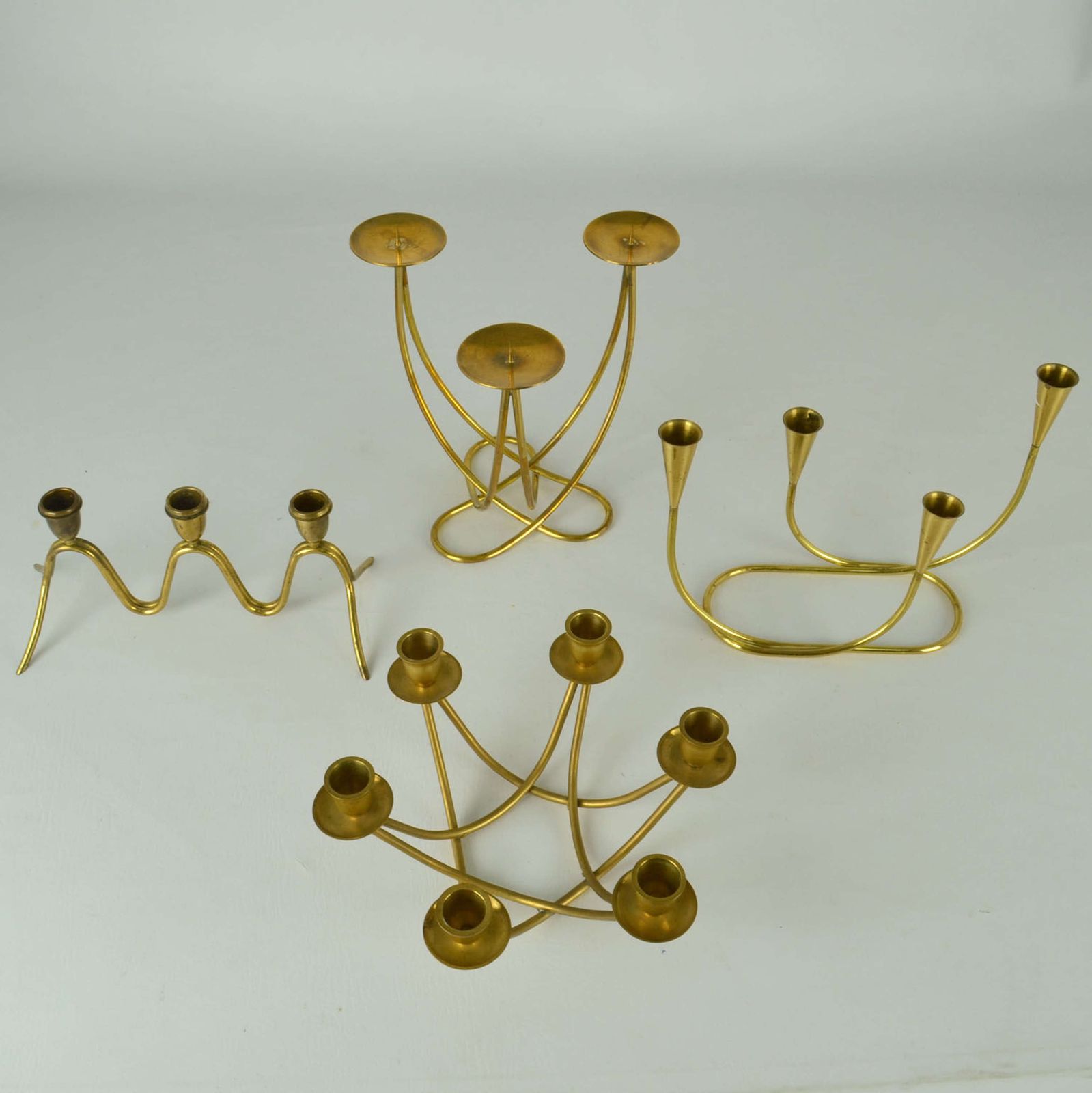 View Larger Image Of Group Of Four Brass Candelabras With Organic Curv photo for sale