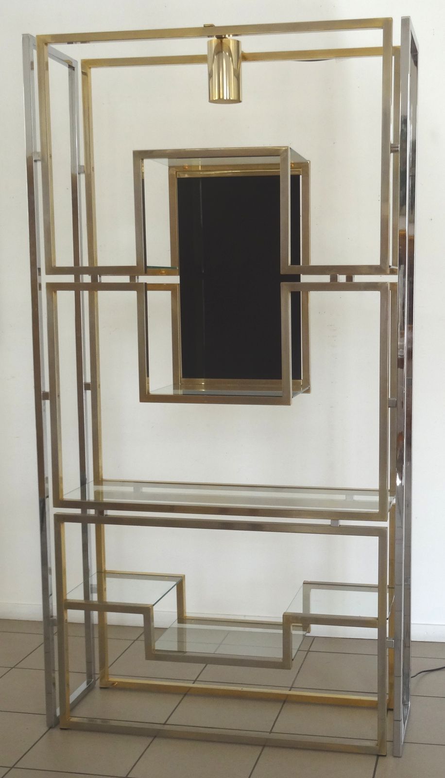 An Illuminating Book Case In Gold And Chromium Plated Aluminium With Black Tinted Glass.