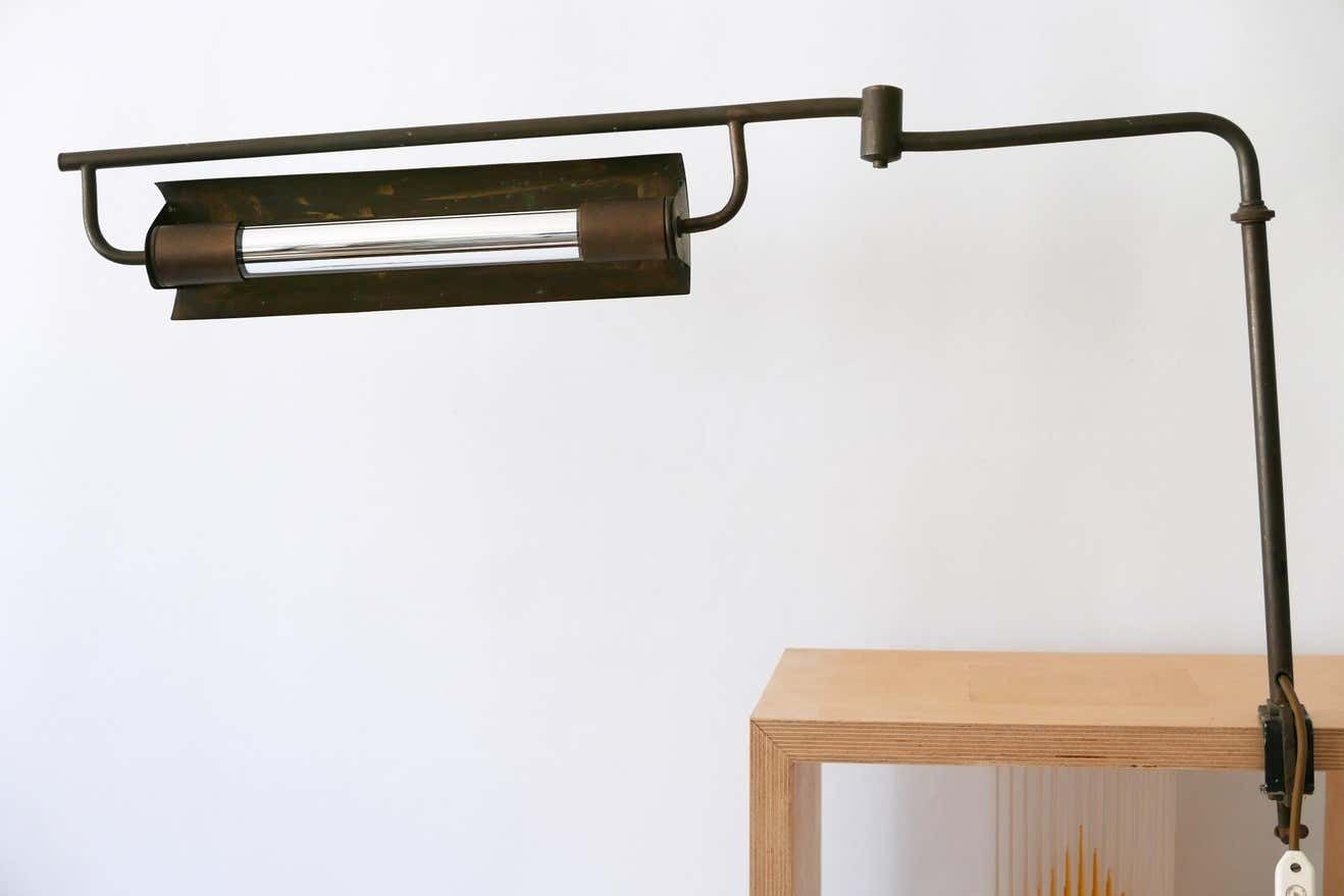 photo vinterior Exceptional Modernist Bauhaus Articulated Brass Clamp Table Lamp, Germany, 1930s