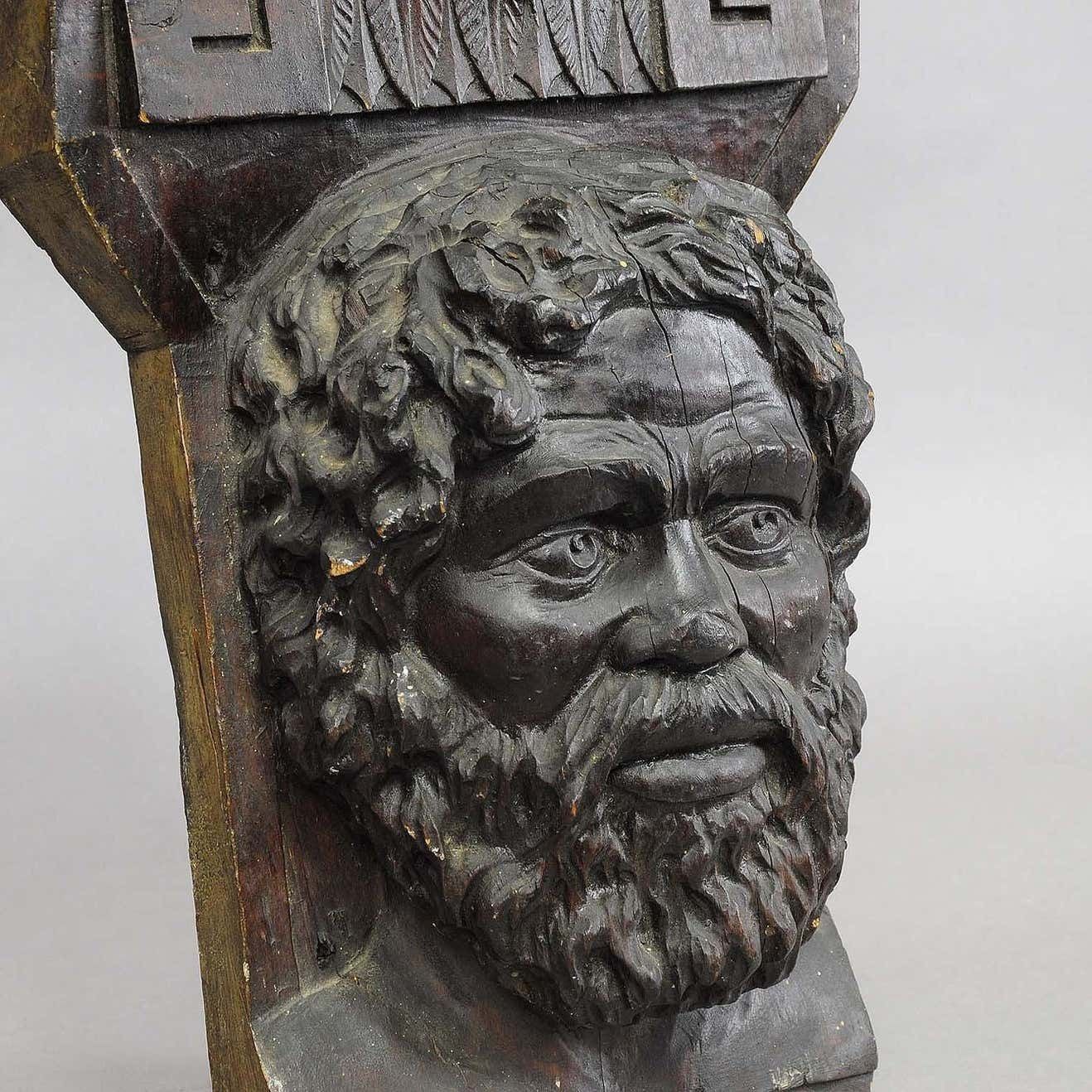Wooden Sculpture Of A Masculine Face photo 765.0