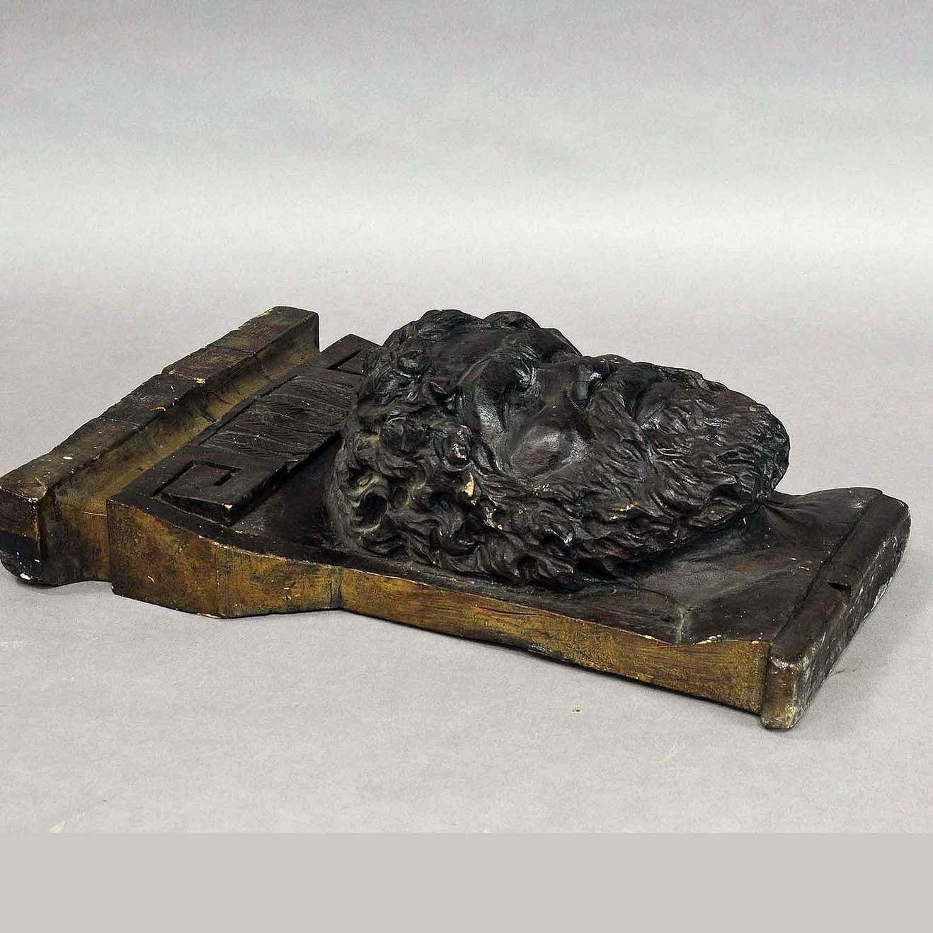 Wooden Sculpture Of A Masculine Face photo buy